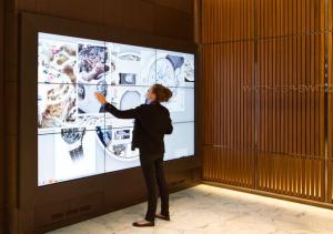 image of person standing at digital wall