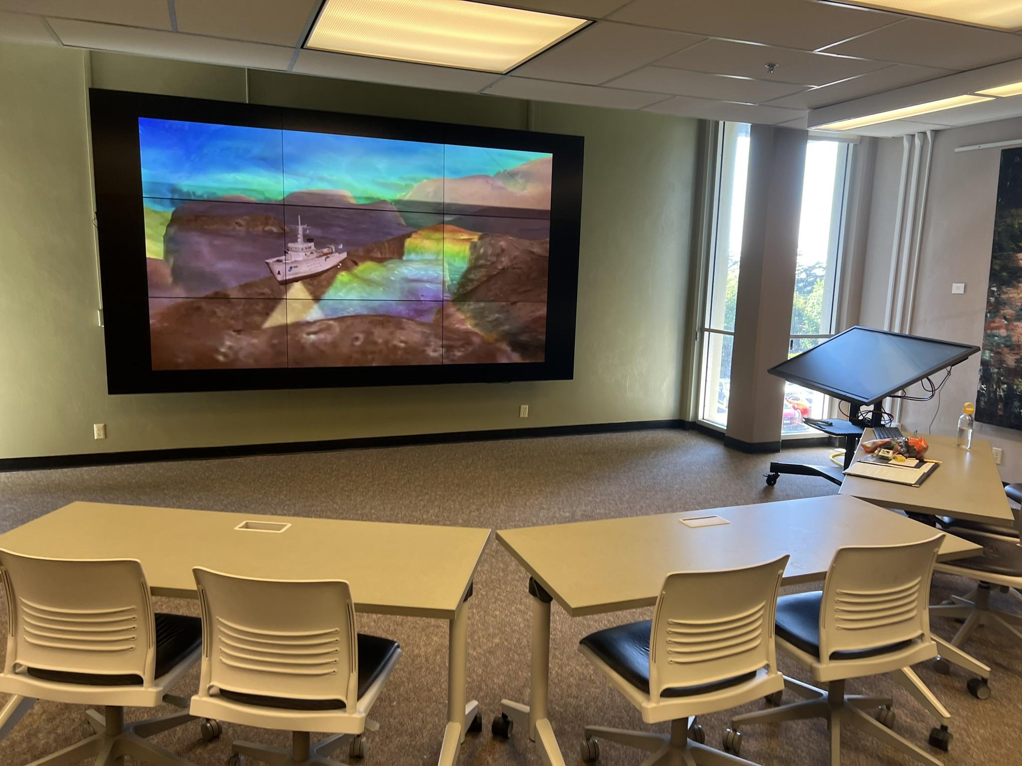 image of digital wall, instructor's station, and tables and chairs