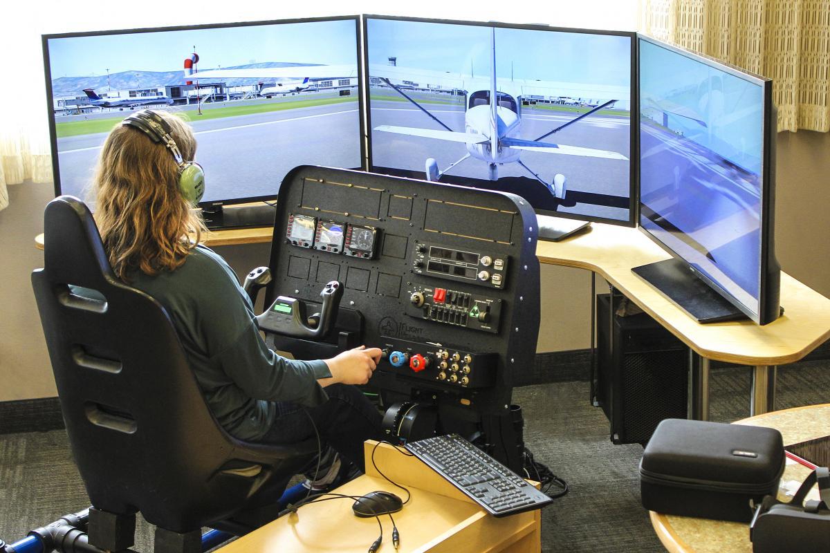 image of person sitting at flight simulator stations