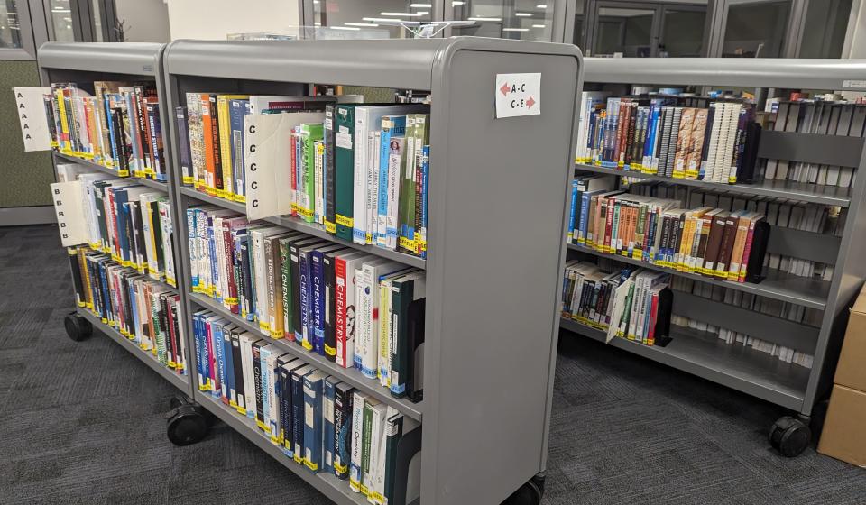 image of book stacks holding reserve text books